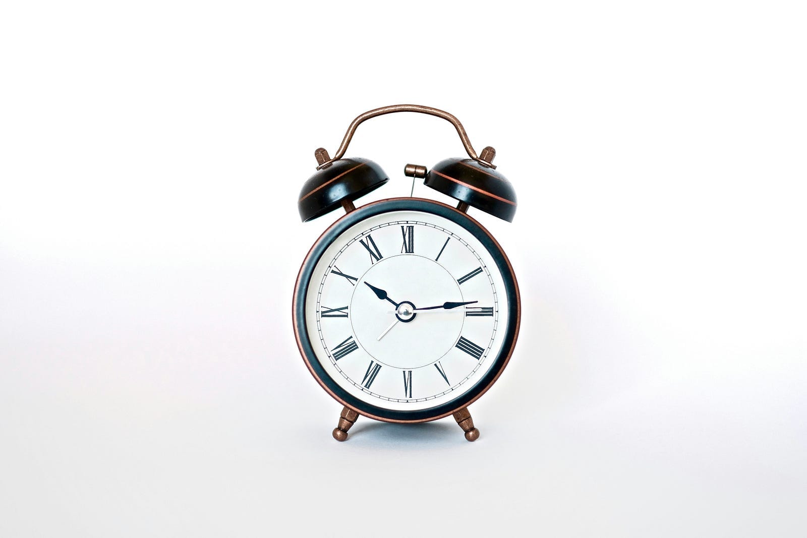 A classic black and white alarm clock for a minimalist bedroom decor.