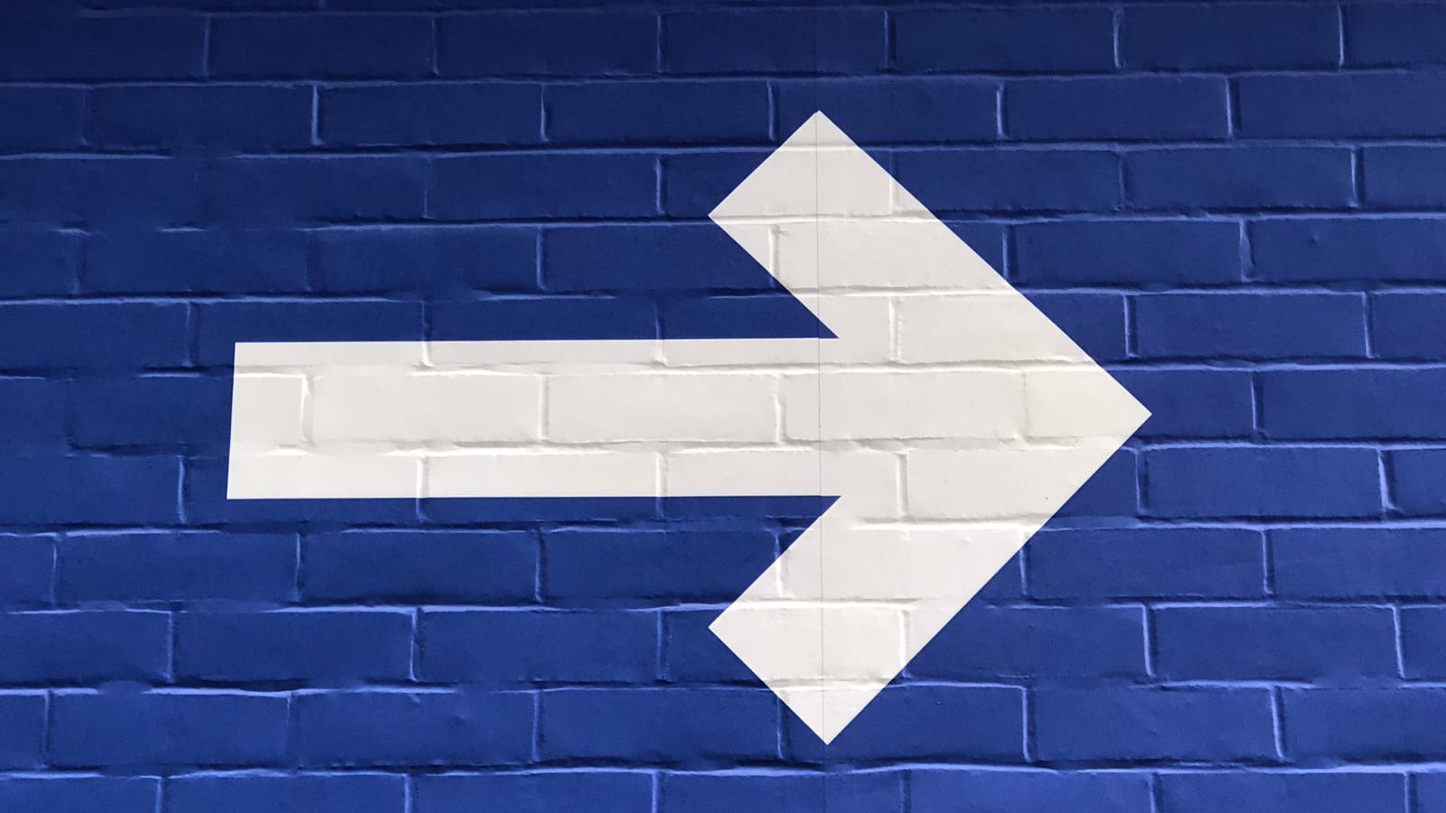 Blue wall with arrow on