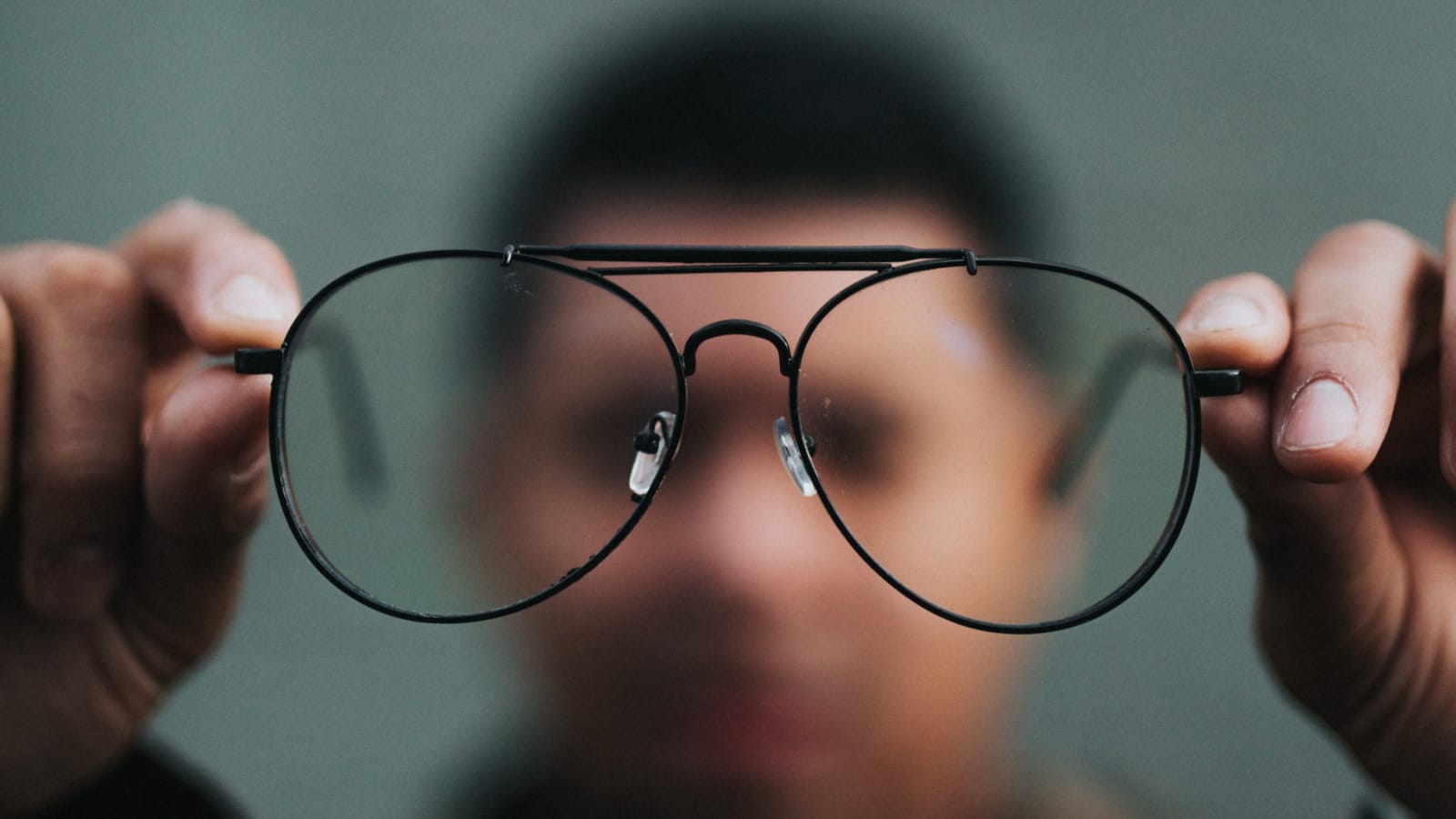 Someone holding glasses up