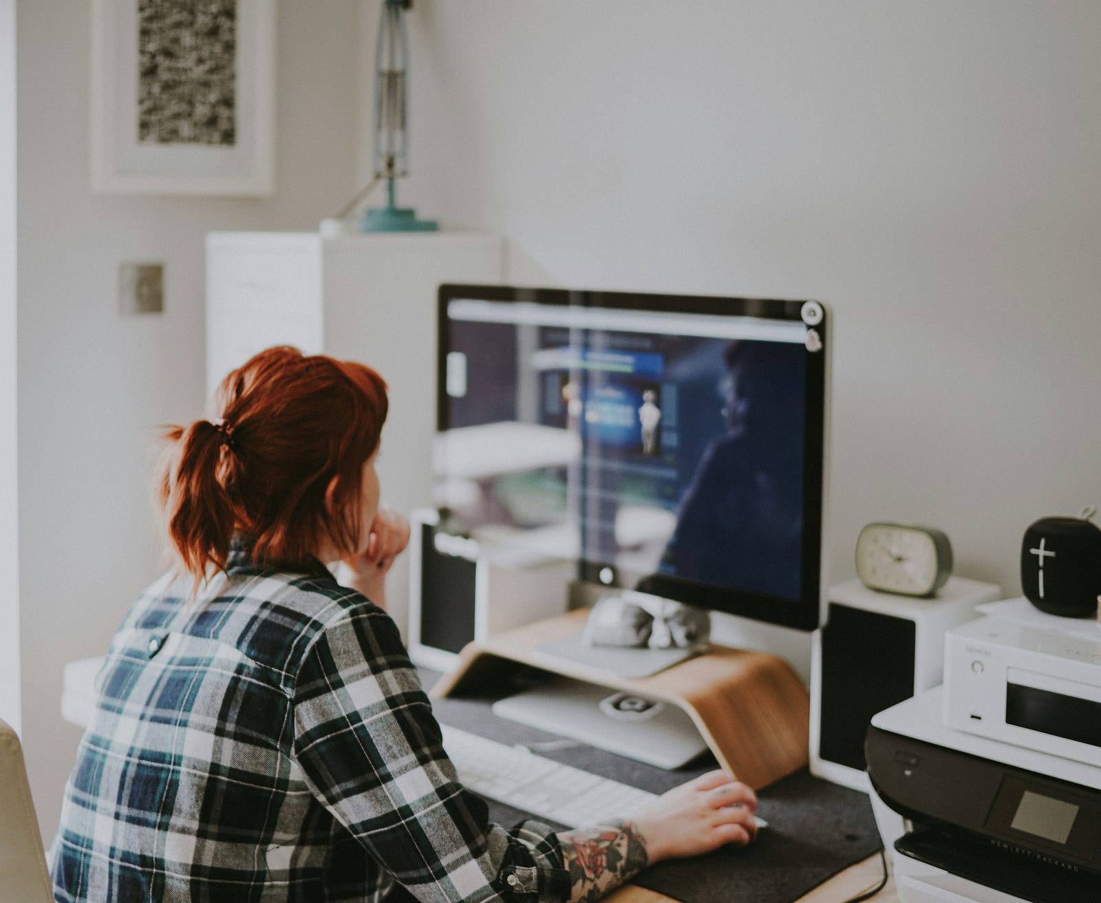 A solopreneur sitting in front of a computer screen.