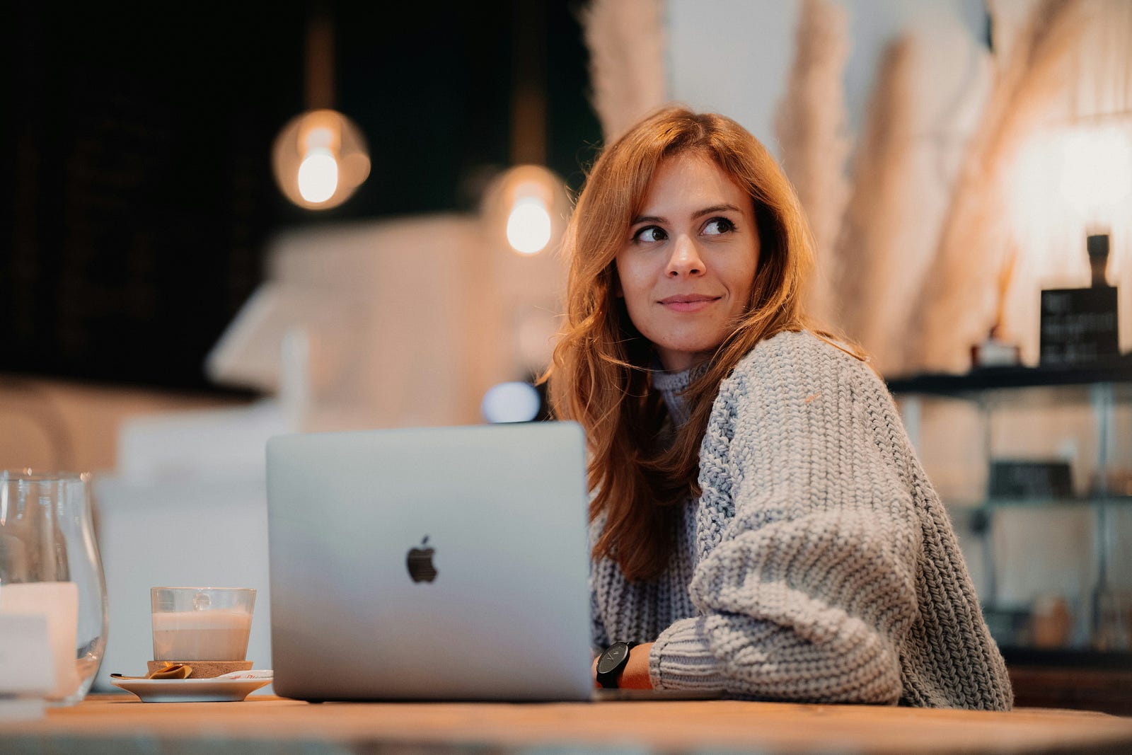 A one-person business owner on their laptop in a coffee shop.