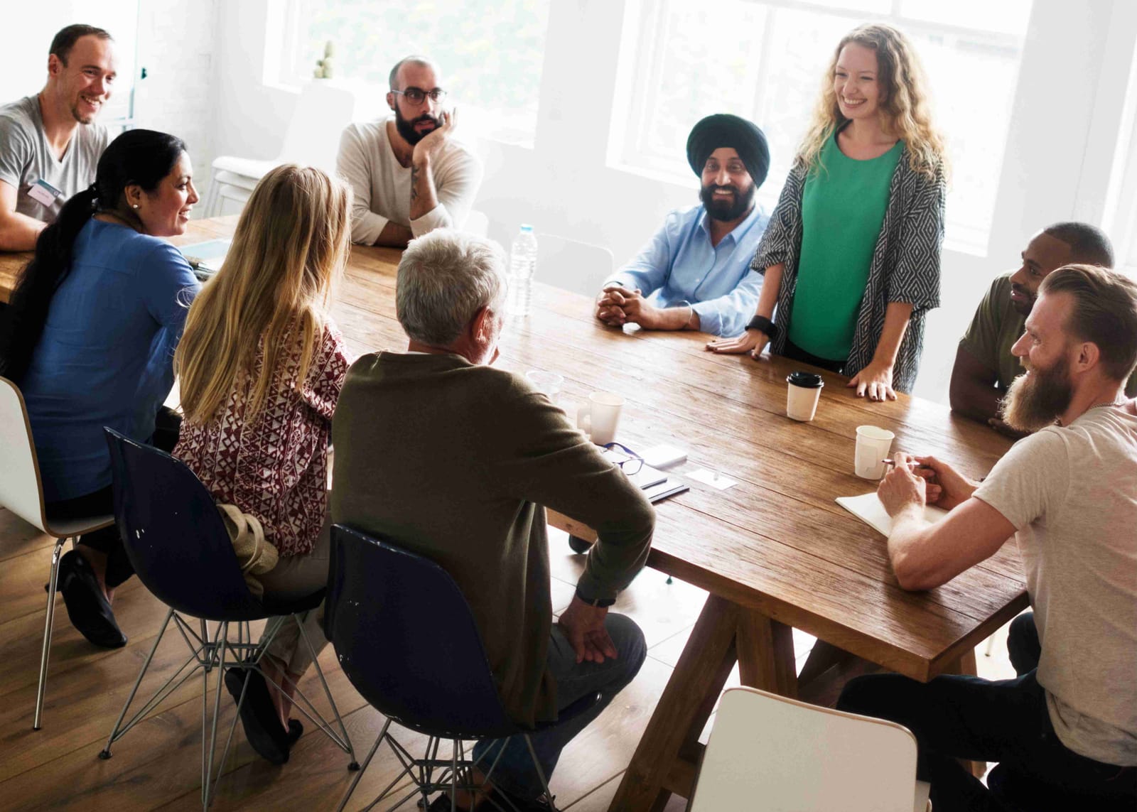 A group of people around a table having a casual meeting