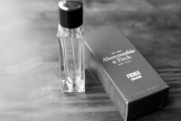 A Abercrombie bottle of perfume on a table next to packaging.
