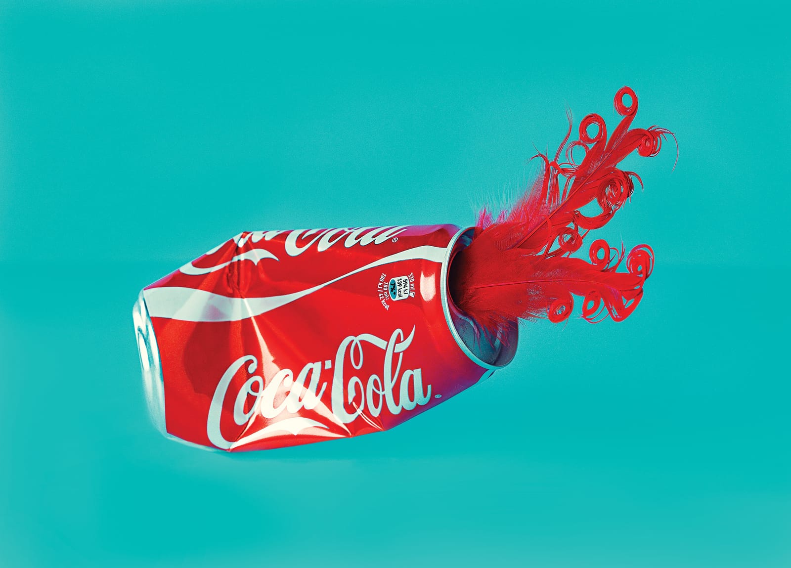 Crushed Coca-Cola can with a red feather protruding, symbolizing the aftermath of a marketing strategy gone wrong