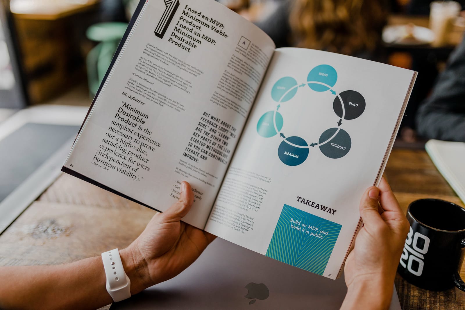 Person holding open a branding book with text on the pages visible