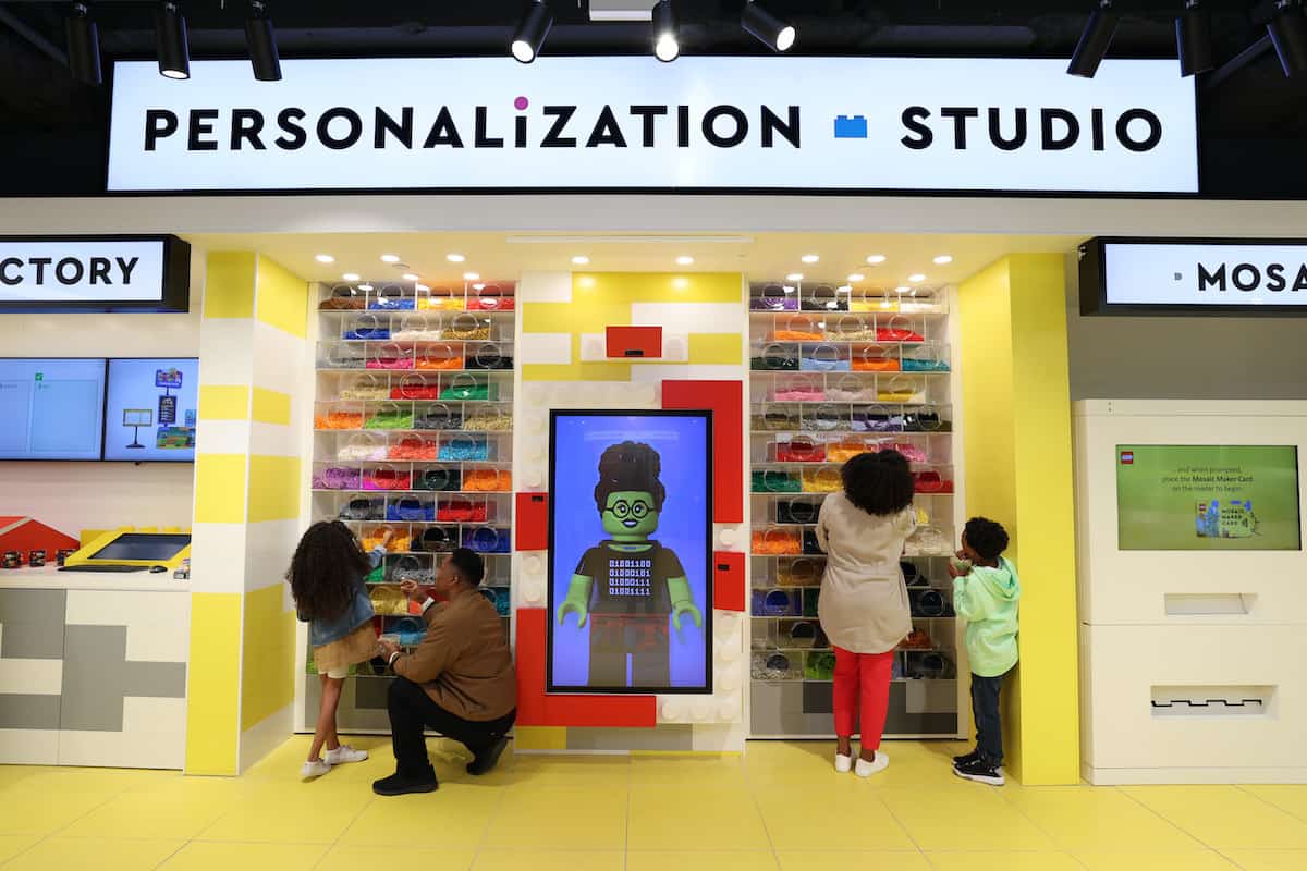 Lego Personalisation Studio with enthusiastic individuals engaging in creative activities, expressing their ideas and building unique creations in the context of Conversational Marketing blog post.