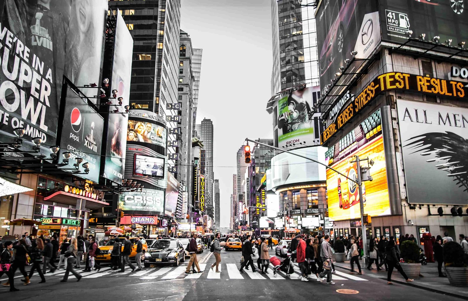 A black and white photo of a busy city street with hundreds of Advertisements..