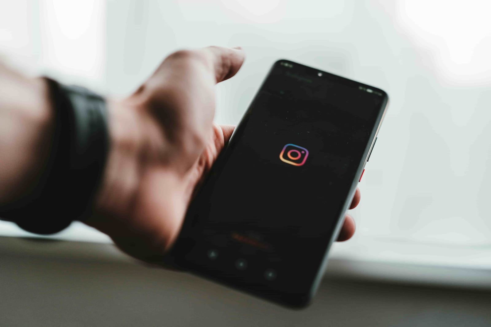 Man holding a mobile in his hand on Instagram