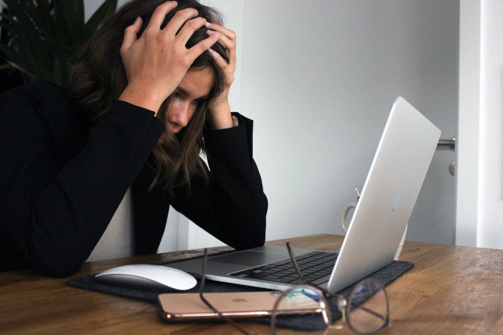 Women with hand on head looking stressed