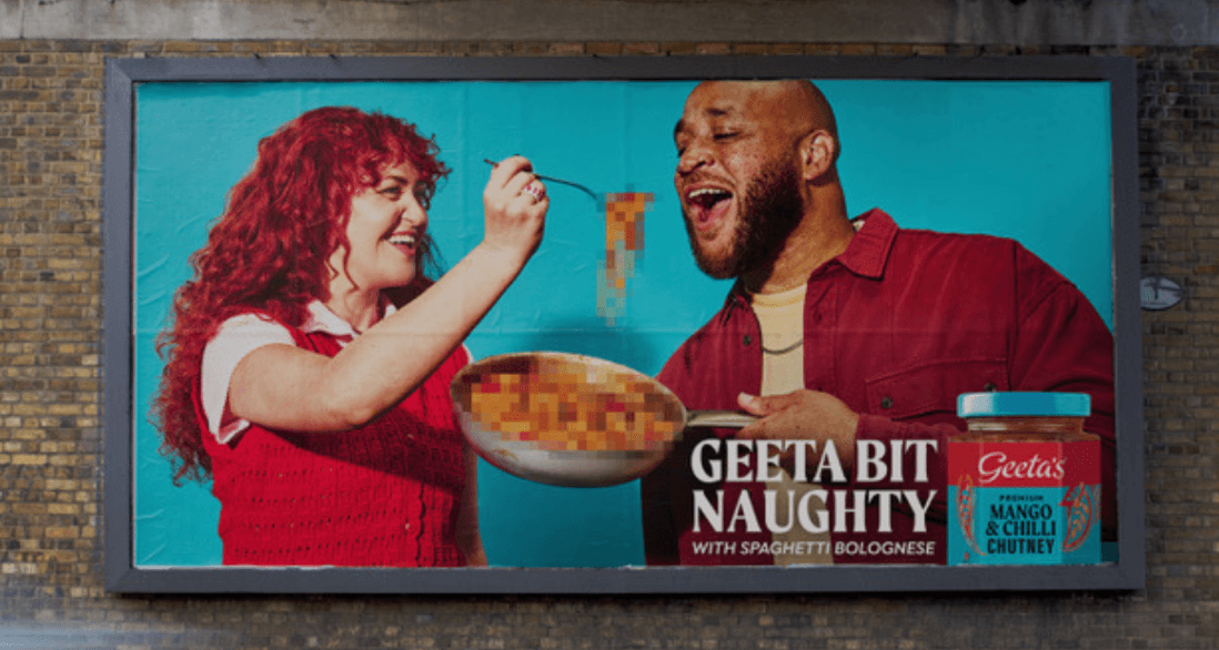 Billboard of a woman feeding a man spaghetti from a pot with text: "Geeta Bit Naughty with Spaghetti Bolognese." A jar of Geeta's Mango & Chilli Chutney is shown on the right.
