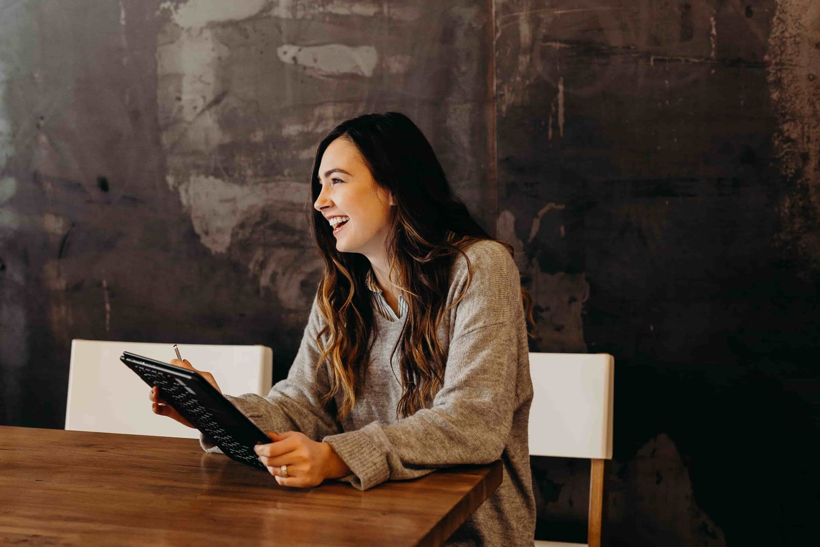 Young female looking happy on business laptop