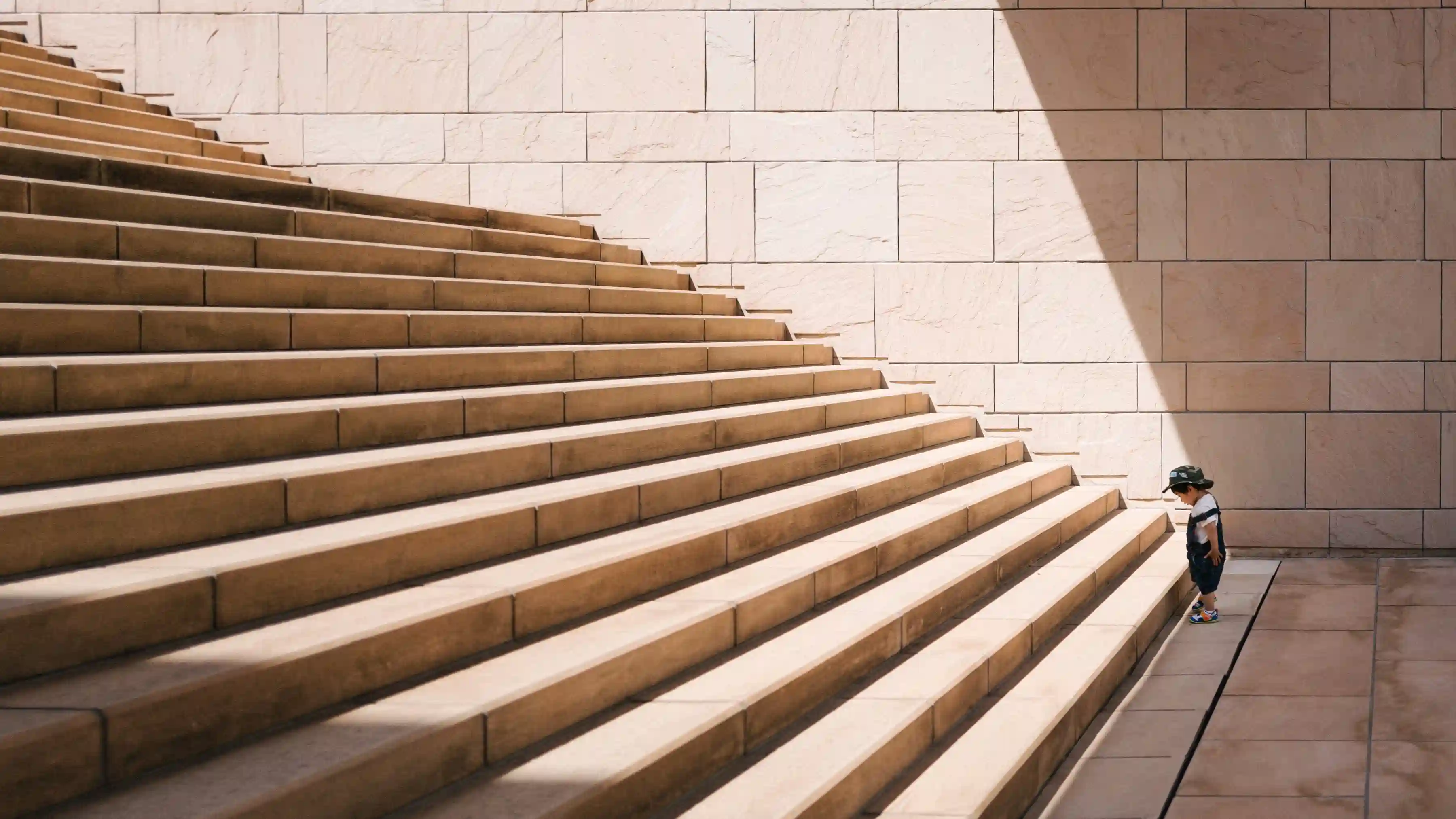 A young child looking at giant steps to illustrate the effort it takes to take action
