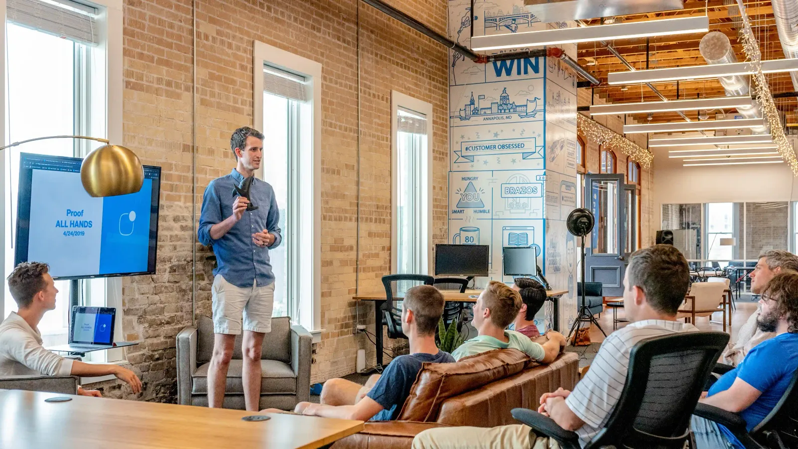 A man standing in front of a group of people giving a presentation