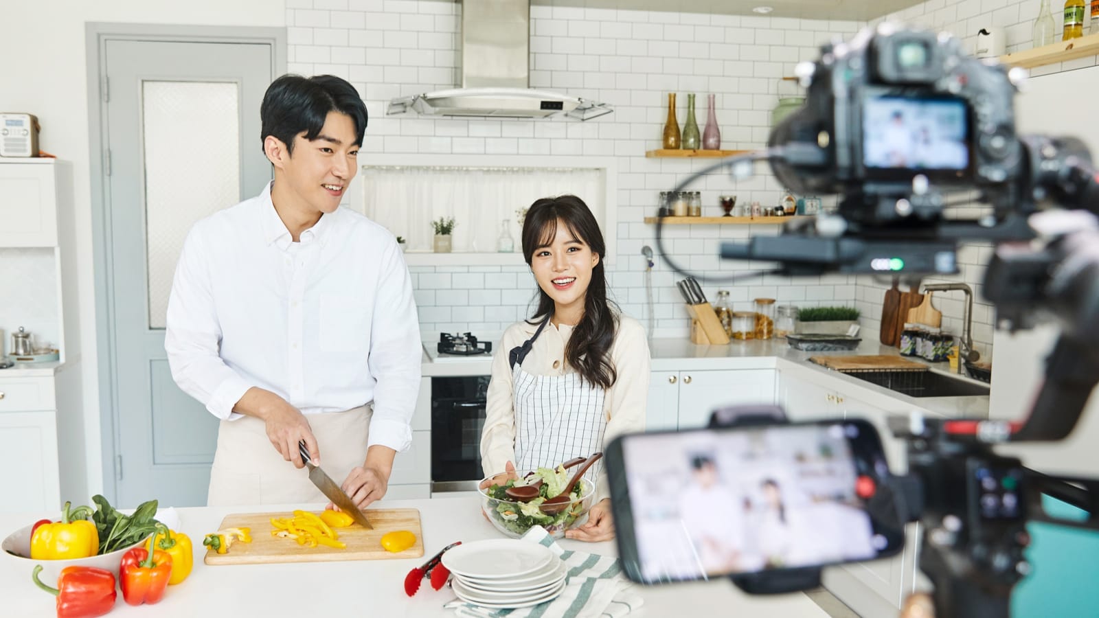 two chefs recording a cookery show on camera