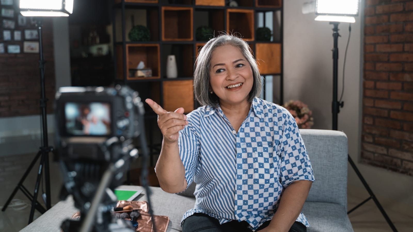 woman speaking and pointing into camera