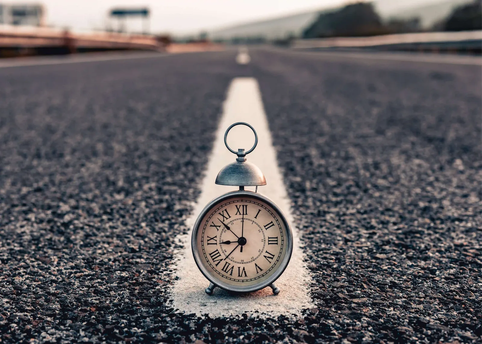 A clock in the middle of the road, illustrating the ability to control one's own schedule.